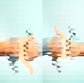 One hand showing thumbs up, one showing thumbs down